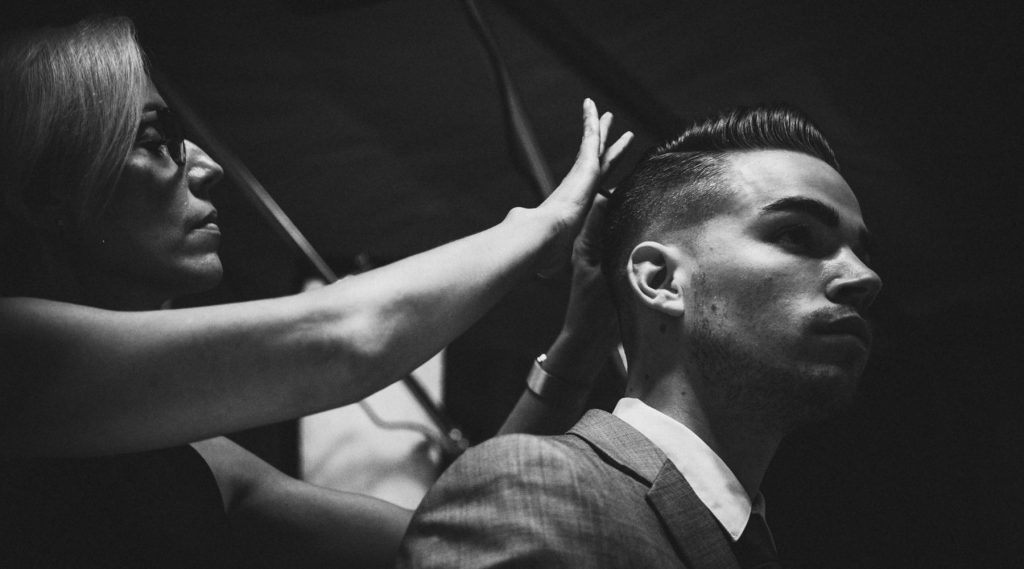 Pivot Point stylist completing a men's hair design