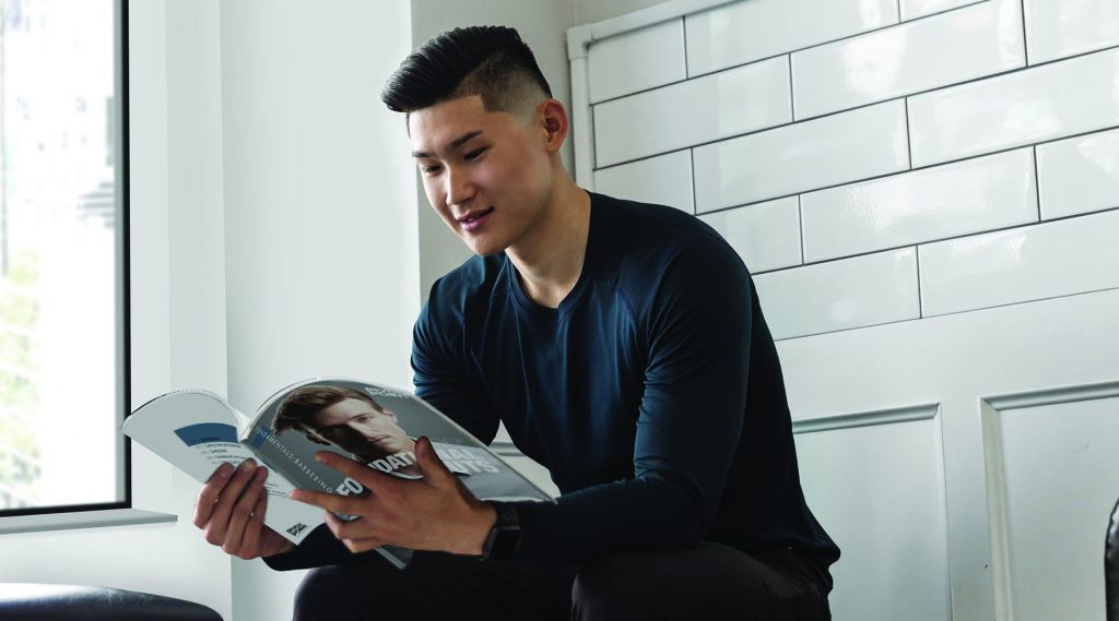 Pivot Point student reading Pivot Point Fundamentals: Barbering.