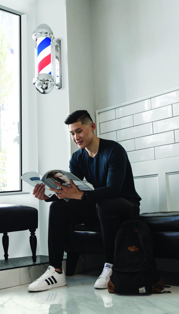 Pivot Point student reading Pivot Point Fundamentals: Barbering.