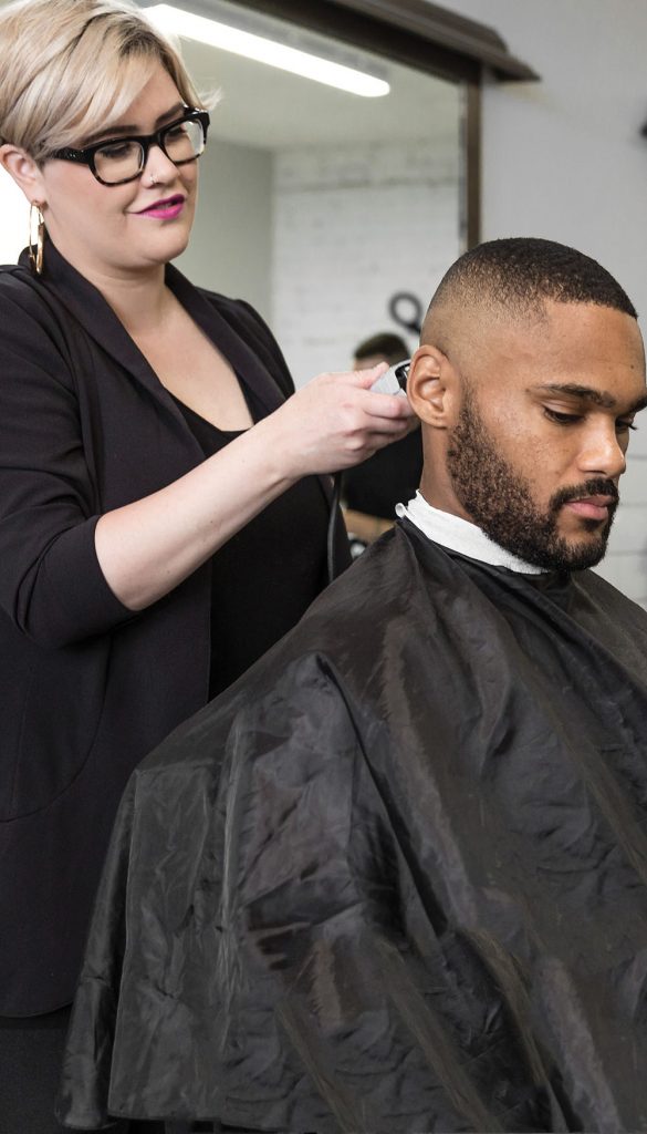 Pivot Point stylist completing a men's hair design