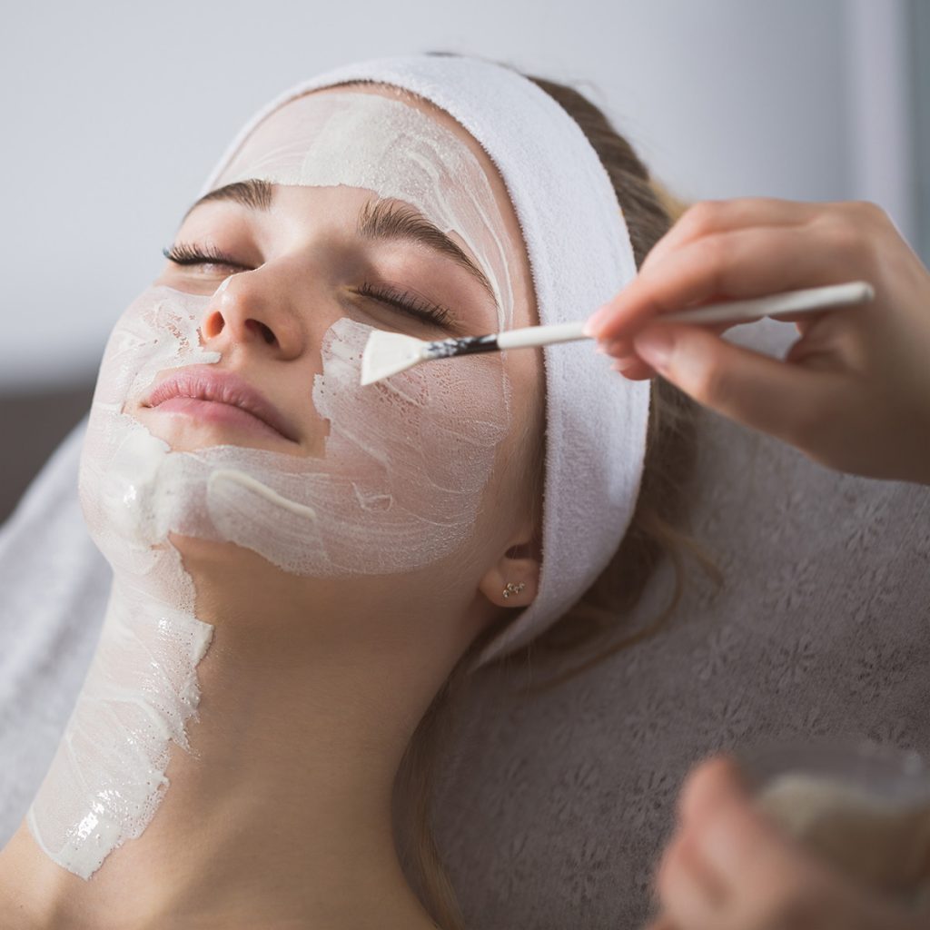 Pivot Point esthetician completing facial treatment with client