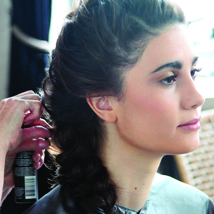 Dark hair. Hair dresser doing hairstyle