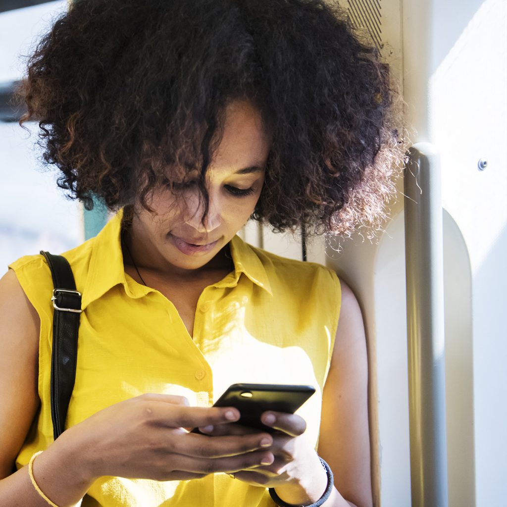 Young woman using a smartphone in the subway