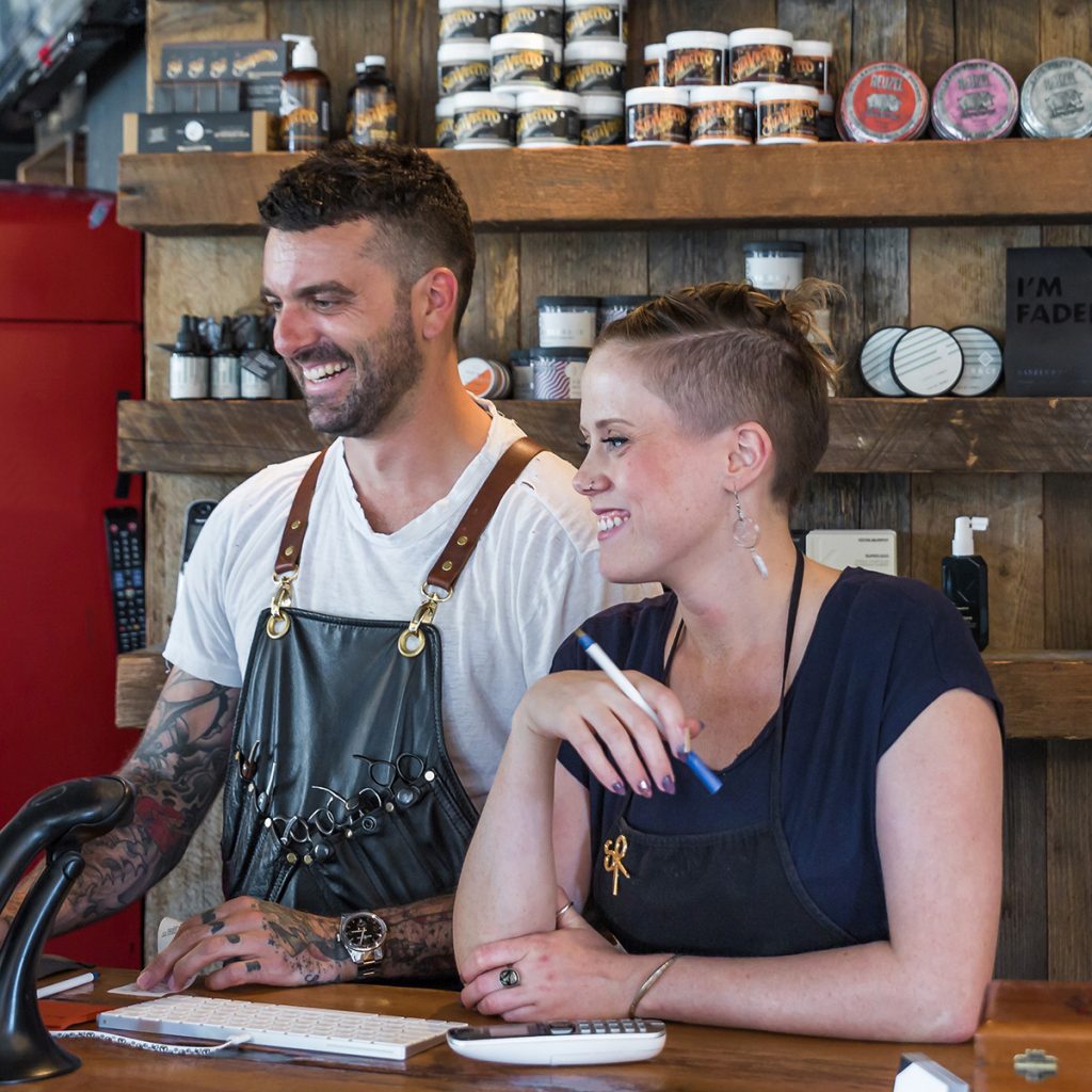 Two barbers ready to open shop